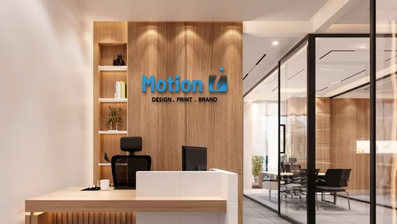 The Motion Imprints logo mounted as dimensional letters on a timber reception wall.
