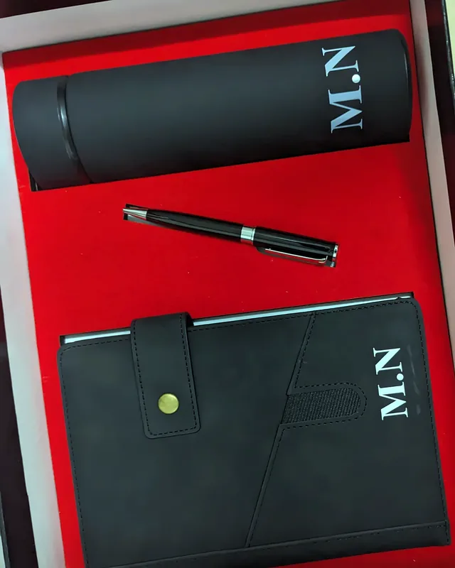 Gift set with a monogrammed flask, pen and notebook in a red-lined box.